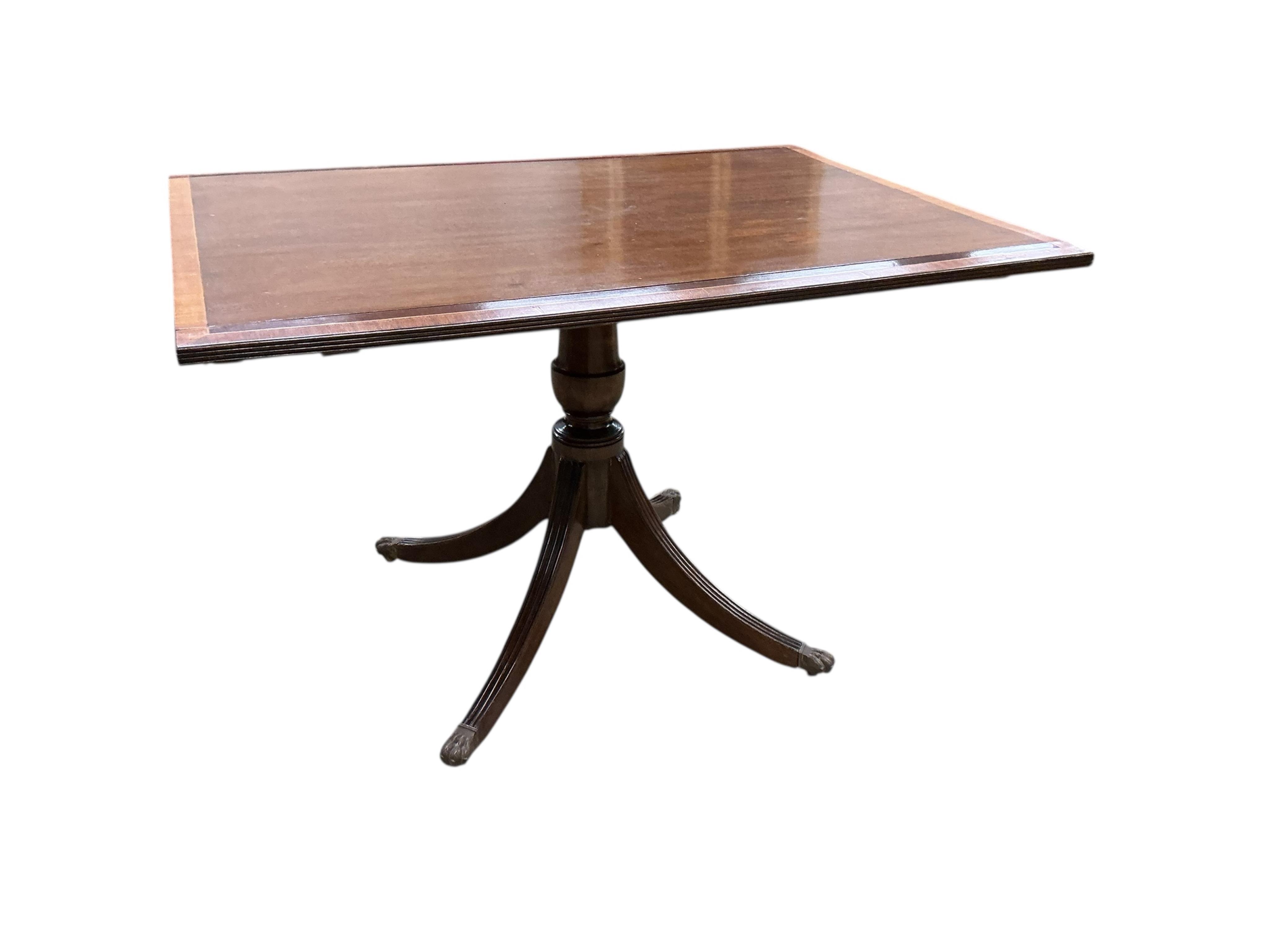 A Regency style mahogany and satinwood banded three pillar dining table, width 320cm extended, two spare leaves, depth 114cm, height 74cm